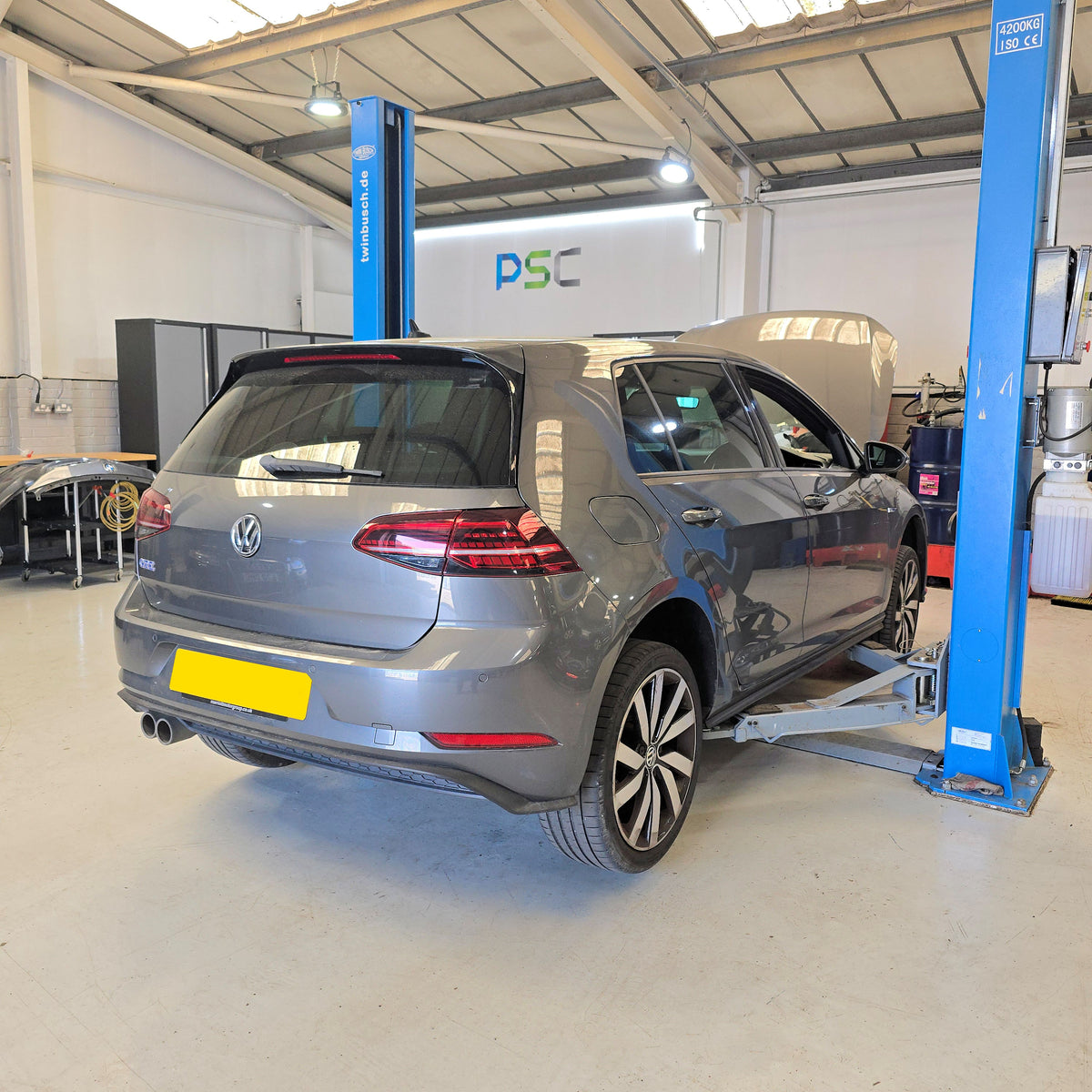 Volkswagen Golf GTE Hybrid for service inside PSC Autocentre workshop in Cheltenham, a specialist German vehicle service centre.