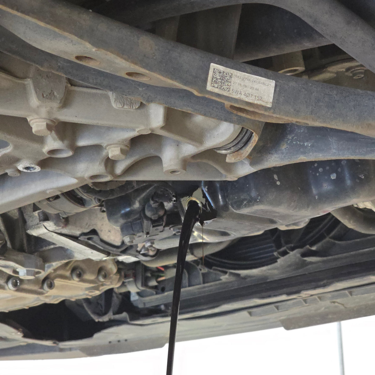 Volkswagen on hydraulic lift inside PSC Autocentre workshop in Cheltenham, a specialist German vehicle service centre